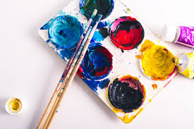 Paint palette with vivid colors and brushes.